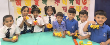 A group of Lower students having fun - show and tell for the colour yellow!